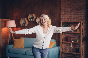 Sticker - Photo portrait of lovely retired woman spread hands dance have fun dressed casual outfit cozy home interior living room in brown warm color