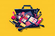 Assorted makeup products in open bag from above on a yellow background