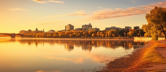Fototapete - Picturesque view of trees in the foreground with a tranquil river flowing in the background, captured at River Landing in Saskatoon Saskatchewan