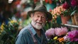 © iuricazac - An elderly man with a white beard and a green hat smiling at the camera surrounded by a vibrant display of colorful flowers in a market setting.