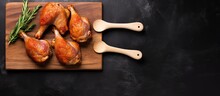 Fresh Raw Duck Drumsticks Arranged On A Rustic Wooden Cutting Board, Set Against A Dark Grey Background In A Top View Flat Lay Style