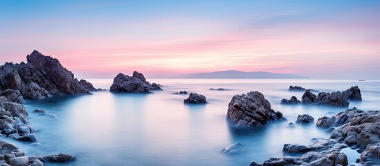 Aufkleber - A serene tropical rocky beach at sunrise captured with a long exposure technique, creating a soft and dreamy effect on the landscape
