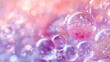 split background with soft pink and lavender tones, featuring clusters of transparent bubbles floating gently across both sections.