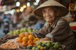 An elderly Asian vendor smiles warmly, his eyes crinkling with a lifetime of stories, as he offers local delicacies in a bustling market.