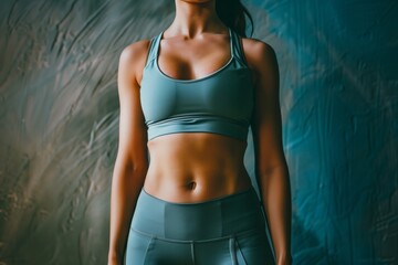 Wall Mural - person wearing sports bra and leggings revealing sixpack