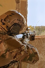 Man wearing a military uniform with a rifle