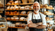 Grinning baker surrounded by delectable pastries in bustling bakery