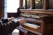 side view of person playing pipe organ