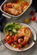 Baked salmon with vegetables on a gray background