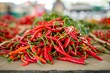 pile of freshly picked chili peppers on a table
