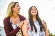© Louis-Paul Photo - A Portrait of trisomie 21 adult girl smilin outside at sunset with family friend