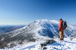 © studioworkstock - hiker admiring view from snowy mountaintop, clear sky