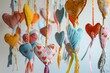handsewn mobile with textile hearts and ribbons in nursery