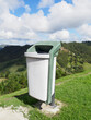Recycling trash bin stands outdoor in mountains. Nature,