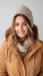 © Molang Visual - portrait of a beautiful young blonde woman in a brown jacket and hat smiling at the camera