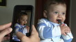 © Marco - Parent taking photo of baby. Mother filming infant child with cellphone