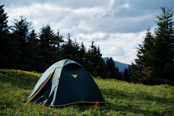 tourism and traveling concept. beautiful summer landscape with mountain forest and tourist tent.