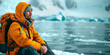 Hiker contemplating the vast frozen landscape of the arctic.