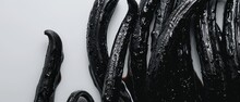   A Lineup Of Black Tubing Arranged On A White Background, Adorned With Droplets Of Water
