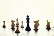 © alexkich - Chess game with black and white wooden chips on wooden board. At sunset. Realistic.