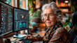 A senior woman with silver hair and glasses gazes confidently at the camera, with multiple computer screens filled with code in her warm, plant-filled office.