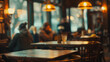 © SashaMagic - People socializing in a blurred cafe.