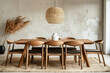 Modern minimalist dining room with wooden table and chairs, under woven pendant lamp, against textured wall with decorative pampas grass in vase, perfect for interior design themes.