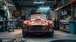 A red vintage sports car is parked in a garage. The car is dusty and has a number 35 on the hood.