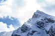 ostry szczyt Kościelec w Tatrach Polskich zimą na tle chmur
