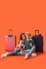 Poster - Couple of tourists with suitcases and passports on orange background