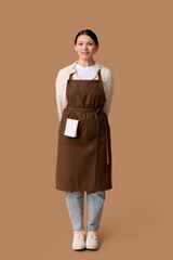 Wall Mural - Beautiful young waitress on brown background