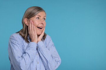 Sticker - Portrait of surprised senior woman on light blue background, space for text