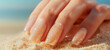 A minimalist one-tone manicure in pale peach, paired with the subtle shimmer of golden sand grains