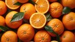 Slices of fresh ripe orange fruits with green leaves as a textural background, full screen close-up, top view.