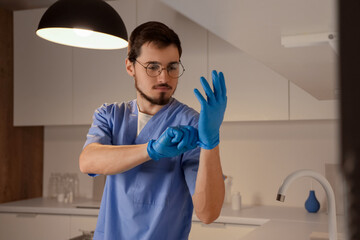 Sticker - Male nurse putting on gloves at hospital in evening