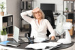 © Pixel-Shot - Mature businesswoman suffering from hot flashes at table in office. Menopause concept