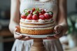 Freshly Baked Cake Ready-to-Eat. Woman Holding Delicious Cake on Stand in Midsection at Home- Lifestyle and Food