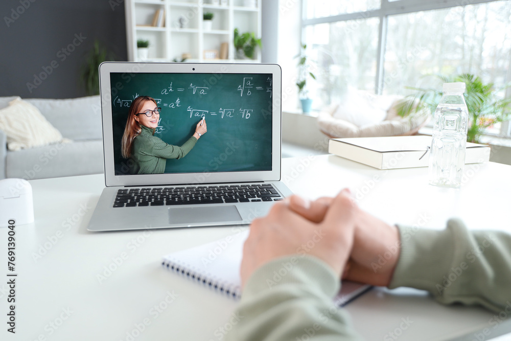 Male student studying Math online at home, closeup