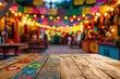 © Sergio Lucci - Empty wooden table and blurred colorful bokeh background. For product display. Cinco de Mayo backdrop.