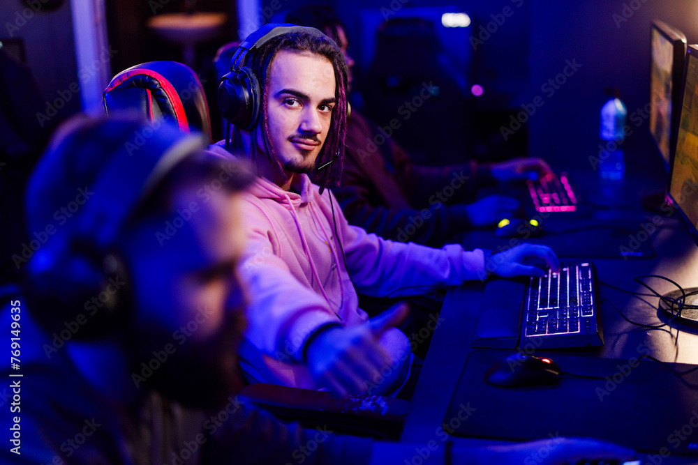 Pro male with dreadlocks esport gamer playing online video games in a ...