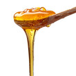 A spoonful of honey is poured out of a jar