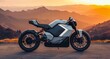 a futuristic motorcycle parked on a road near mountains at sunset