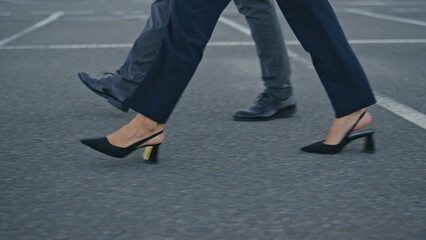 Business people legs stepping city pavement hurrying on meeting close up.