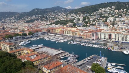 View of the port of Nice baie des anges , Colorful houses in the city of Nice on the french riviera in South East of France with a lot of boats in the harbour.