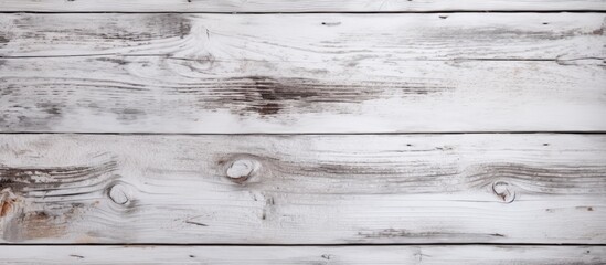 Wall Mural - A close up shot of a rectangular white wooden table with a blurred grey background. The hardwood flooring and monochrome photography highlight the intricate wood pattern and metal accents
