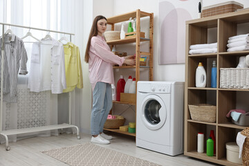 Poster - Beautiful young woman with basket of napkins in laundry room