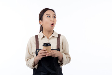 Cheerful young asian woman barista in casual work attire happily holding a takeaway coffee cup, isolated white background, joyful barista presenting takeaway coffee, small business or startup.