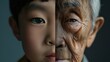 © Phoophinyo - The face is divided into two halves - half of an Asian boy and half of an old Asian man. Distinguishing childhood and old age, aging, maturation, longevity, lifespan, aging, gerontology.