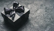 Black gift box on a dark contrasted background, creating a romantic atmosphere. Typically used for birthday, anniversary presents, gift cards, post cards.