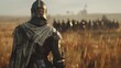 A lone knight stands with back to the camera gazing out at the vast field in front of them. Despite being surrounded by other . .